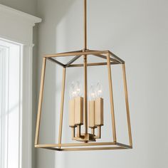 a light fixture with three candles hanging from it