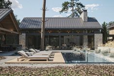 a house with a swimming pool and lounge chairs