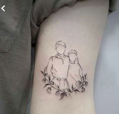 a woman's arm with a small tattoo of two people sitting on top of each other