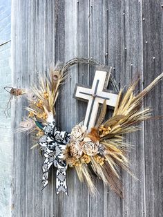 a cross and some flowers on a wooden fence