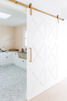 an open sliding door in a white kitchen