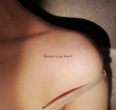 a woman's back with the words forever is my heart written on it