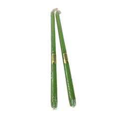 two green chopsticks sitting next to each other on top of a white surface