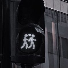 a traffic light with an image of two people holding hands