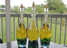 two bottles filled with liquid sitting on top of a table