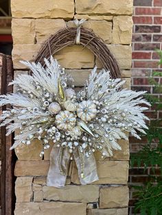 a wreath is hanging on the side of a brick wall