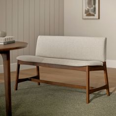 a wooden bench sitting on top of a green rug