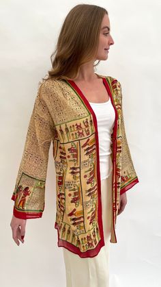 This vintage Egyptian Revival design lightweight jacket or shorter length robe is very much in the spirit of the 1920s and I am dating it to the 1970s or later as it is hard to give a precise date that it was made. It is made from a lightweight batiste cotton fabric with an all over and detailed design of Egyptian motifs, symbols and figures. There are ties at the front and a press stud fastener.  When laid flat the measurements are: Length from the top of shoulder to the bottom hem: 31.5" inche Egyptian Motifs, Pajama Robe, Womens Robes, Lightweight Jacket, Cotton Fabric, Sleeve Length, Bathing Beauties, Clothes For Women, Fabric