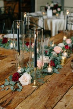 a long table with candles and flowers on it