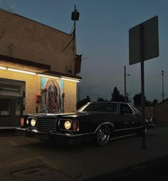 a black car parked in front of a building