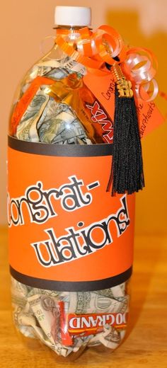 a bottle filled with candy and candies on top of a wooden table