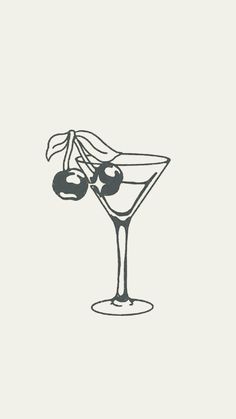 a martini glass with olives in it