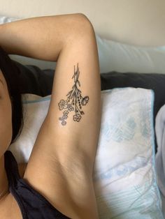 a woman laying on top of a bed next to a pillow