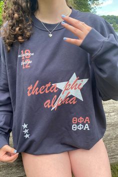 a woman with her hand on her hip wearing a sweatshirt that says, they're delta