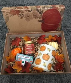 an open gift box filled with fall items