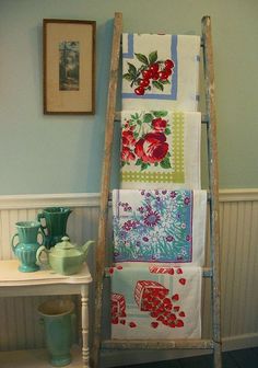 an old ladder is used as a towel rack