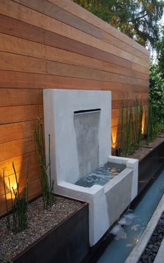 an outdoor water feature in the middle of a garden