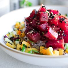 a white bowl filled with food on top of a table