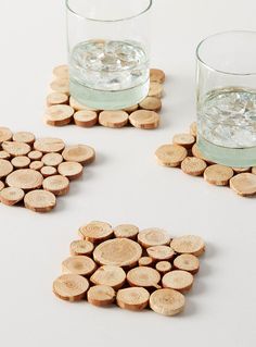 three wine cork coasters with water in the middle and two glasses on each side