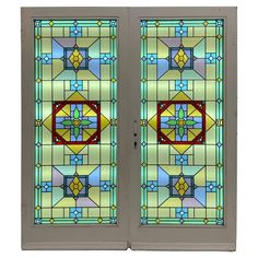 two stained glass doors with decorative designs on them