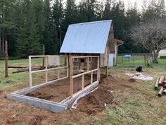 a chicken coop in the middle of a yard