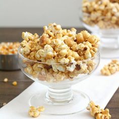 two bowls filled with popcorn sitting on top of a table