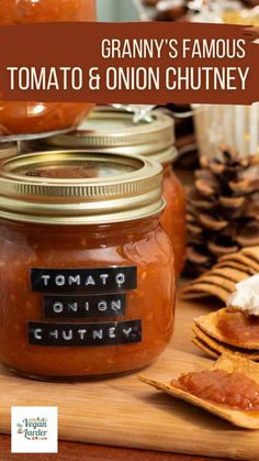 a jar of tomato and onion chutney next to crackers