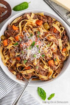 a white bowl filled with pasta and meat