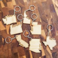 six wooden keychains with the state of texas on them