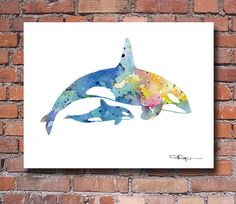 two dolphins in watercolor on a brick wall