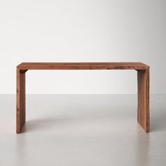 a wooden bench sitting on top of a white floor