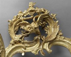 an ornately carved gold headboard and foot board