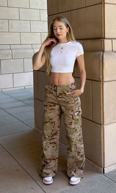 The Ellie Camo Pants are perfect for any occasion. These low-waisted cargo pants feature a camo-print, bungee ties at ankle and waist, giving you the perfect fit. 100% Polyester Casual Camo Pants Outfit, Cami Cargo Pants Outfit, Light Camo Pants, Camo Outfits For Women, Camo Jeans Outfit, Air Force Outfits, Women Cargo Pants Outfit, Army Pants Outfit, Camo Cargo Pants Outfit