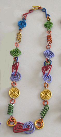 Aluminum Necklace - Anodized aluminum necklace 27" long with hook closure in raspberry, lime, gold, orange, lapis blue, lavendar & peacock blue. All pieces are hand crafted, anodized & dyed by the artist. Non-allergenic as there is no nickel content. Aluminum Foil Jewelry, Aluminum Wire Jewelry, Collar Hippie, Swirl Necklace, Wire Jewelry Tutorial, Lapis Blue, Diy Wire Jewelry, Artful Home, Recycled Jewelry