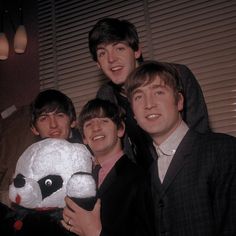 the beatles posing for a photo with their stuffed animal