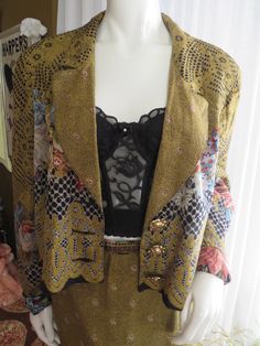 "80's/90's ladies jacket/skirt suit, by CACH'E, in a beautiful floral/honeycomb-like print, in colors of gold, black, blue, beige, brown rayon fabric. The shoulder padded floral lined Jacket is a size large to the waistline length, that buttons with three 1 1/2\" gorgeous gold metal rose shaped buttons. The Shoulders 18\", Length 20 1/2\", Waist 44\", Sleeves 25\". The Skirt in a size 12, with back nylon zipper, and one button closure, is in a slight fitted style, with Waist 28\", Hip 40\", Leng Vintage Evening Skirt Suit For Fall, Vintage Blazer For Spring Party, Vintage Workwear Sets For Spring, Vintage Formal Sets For Fall, Fitted Fall Costume Sets, Fitted Costume Sets For Fall, Vintage Skirt Suit For Party, Retro Fitted Party Blazer, Retro Party Blazer