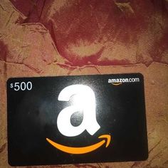 an amazon gift card sitting on top of a bed