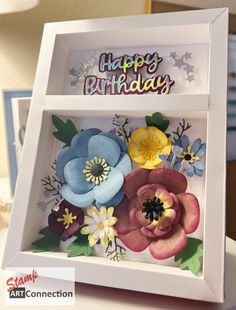 a birthday card in a box with flowers on it