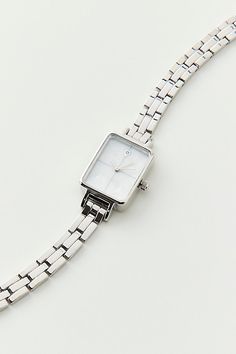 Classic metal rectangle watch. Essential watch style with a linked chain in polished metal complete with a rectangle style face. Features Classic metal rectangle face watch Linked banded watch Simple rectangle watch case Glass face Lined chain band In silver or gold tone metal Clasp closure Content + Care Mixed metal, glass Avoid contact with water Imported Size Strap length: 7.24" l Case: .98" x .78" | Classic Metal Rectangle Face Watch in Silver, Women's at Urban Outfitters Rectangle Watch, Rectangle Face, Silver Watches Women, Classic Metal, Jewelry Lookbook, Mixed Metals, Silver Watch, Womens Watches, Urban Outfitters