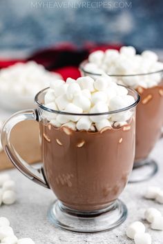 two mugs filled with hot chocolate and marshmallows