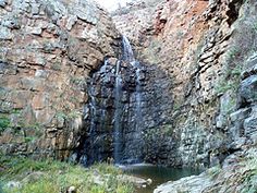 there is a small waterfall in the middle of this canyon