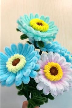 a hand holding a bouquet of colorful flowers