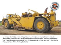 an image of a large yellow truck in the middle of a dirt field with words above it