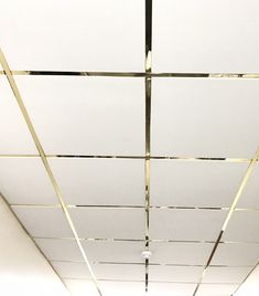 the ceiling is white and has gold lines on it