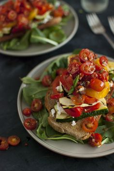 two white plates topped with food on top of a table