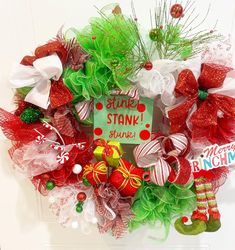 a christmas wreath with stockings and candy canes