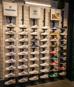 a display case filled with lots of adidas shoes