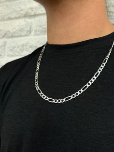 Crafted with precision and elegance, our Sterling Silver Figaro Chain Necklace is a timeless piece that exudes sophistication. Each link is meticulously designed, showcasing a classic Figaro style that seamlessly combines versatility and style. The lustrous sterling silver adds a touch of luxury to any outfit, whether worn casually or elegantly. The sturdy construction ensures durability, making it a staple accessory for everyday wear. Elevate your look with this exquisite Sterling Silver Figaro Luxury Everyday Necklaces For Men, Classic Sterling Silver Figaro Chain Necklace, Classic Silver Figaro Chain Necklace, Sterling Silver Figaro Chain Necklace, Silver Figaro Chain Necklace, Silver Figaro Chain, Silver Link Necklace, Silver Chain For Men, Figaro Chain Necklace