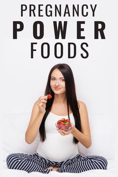 a pregnant woman sitting on the floor holding a bowl of food in her hands and looking at the camera