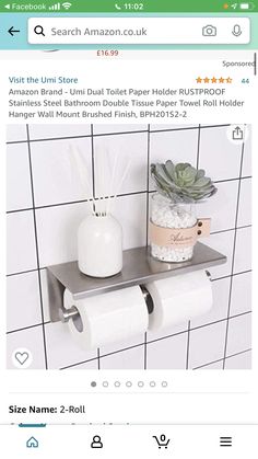 a white toilet paper holder with succulents on it